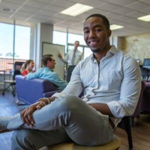 HSU student sitting in the Kelly College lounge